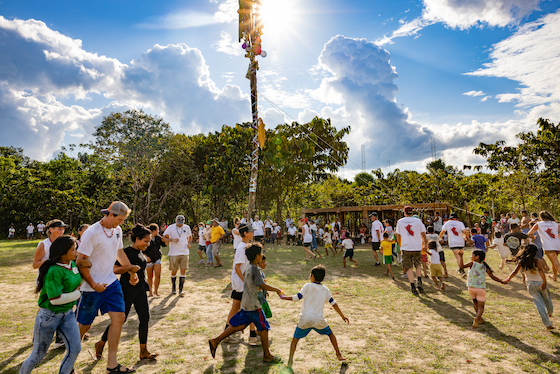 Children and visting celebrating at a festival in Chino, Peru.