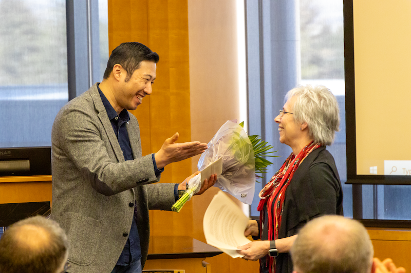 faculty member receiving flowers