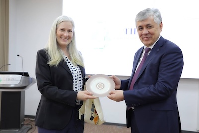 Isa and university official with plaque