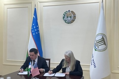 Isa and TUIT representative signing MOU