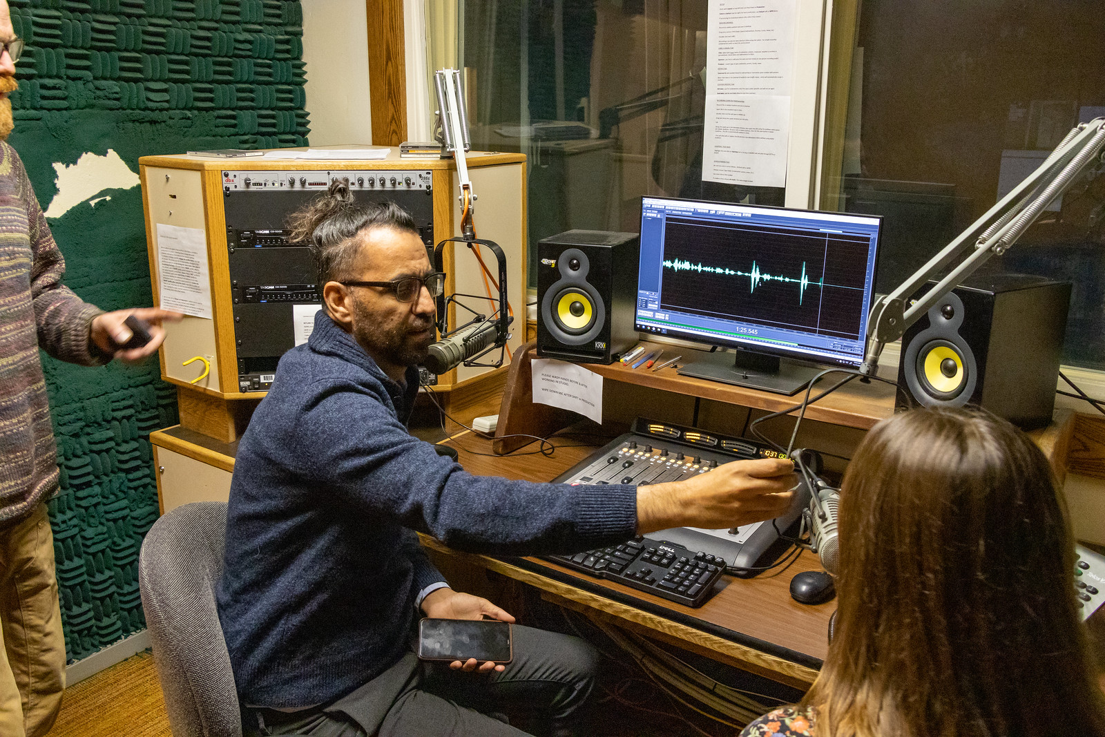 A man at a recording station and computer