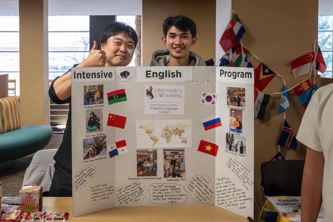 two students sharing a poster during international education week