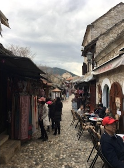 an outdoor restaurant with patrons on a cloudy day