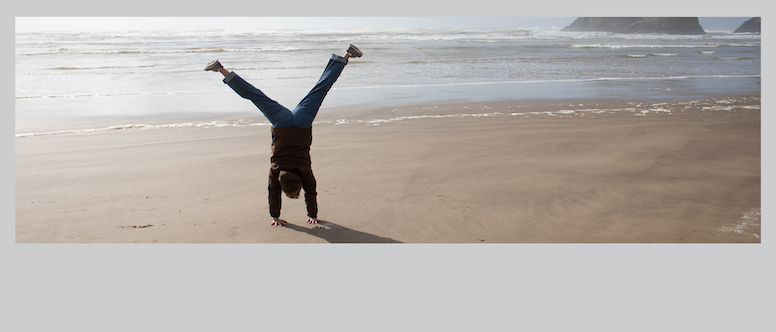 Student doing a cartwheel on a beach in Oregon
