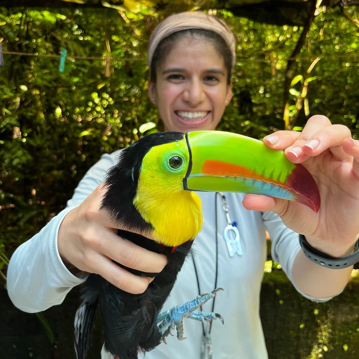 Reina Galvan holding a tropical bird