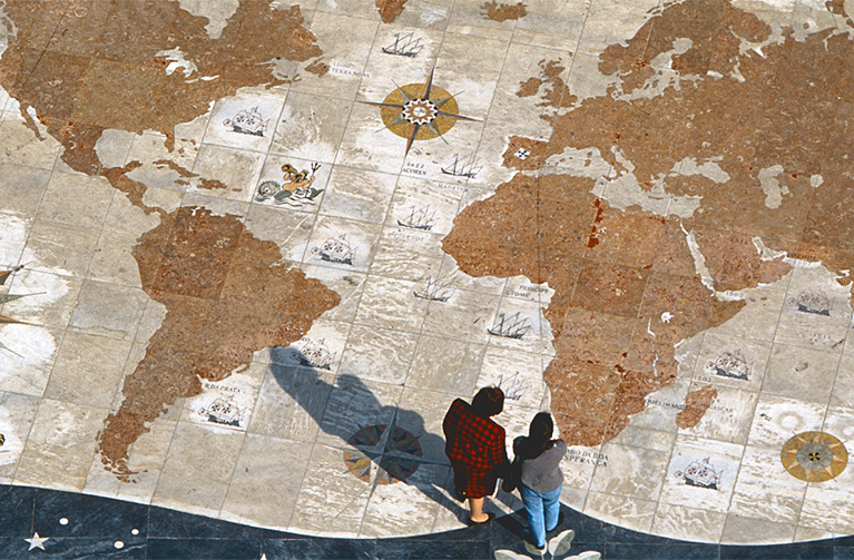 people standing on image of global map