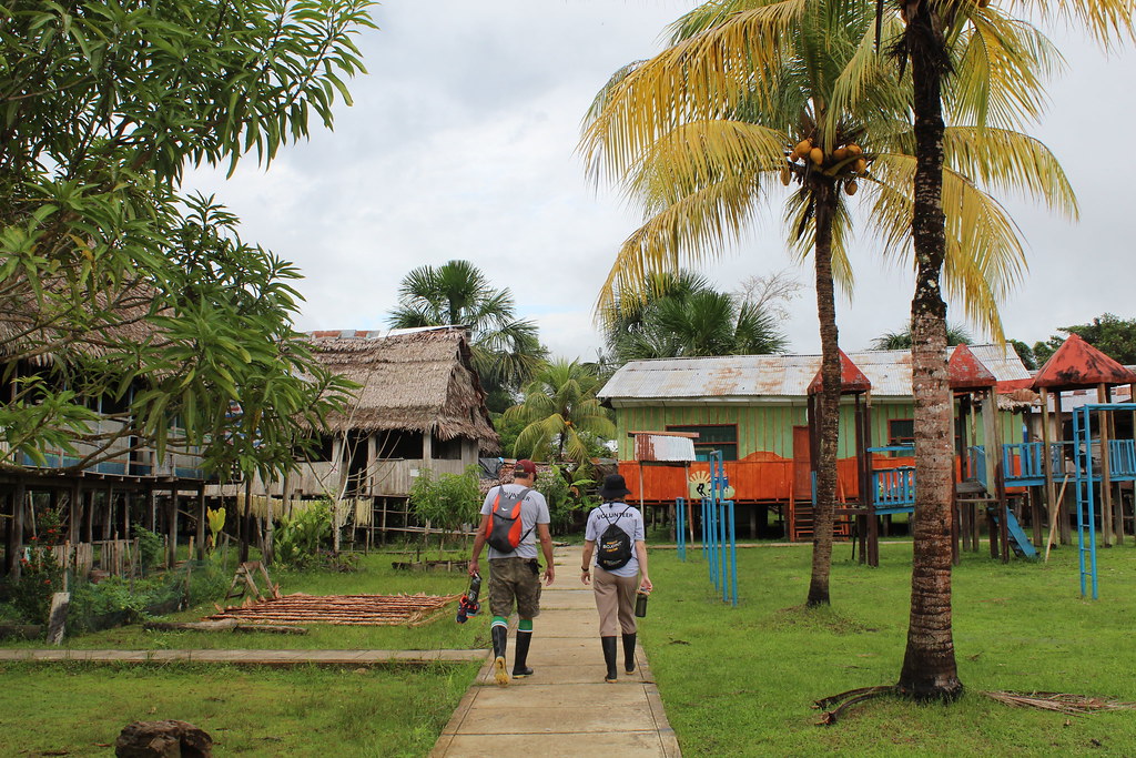 Two faculty walking in schoolyard in Peru