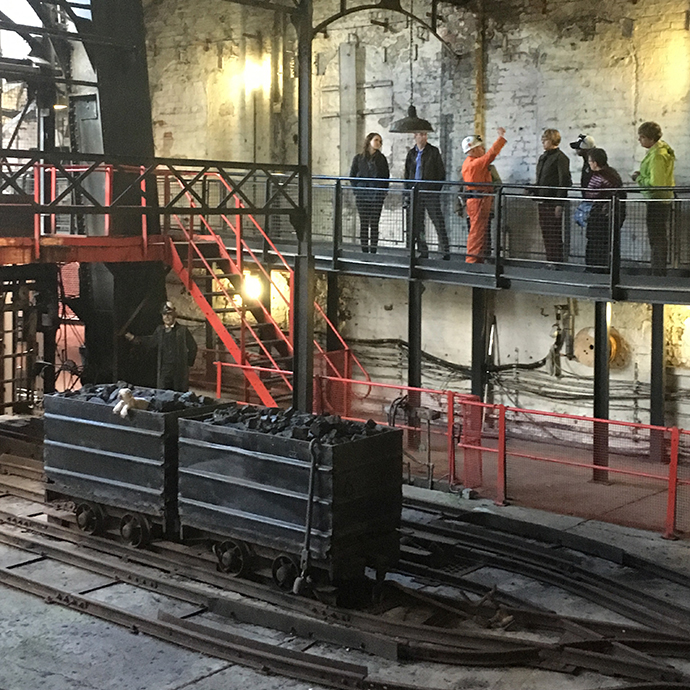 A group of faculty tours a coal mine in Scotland.