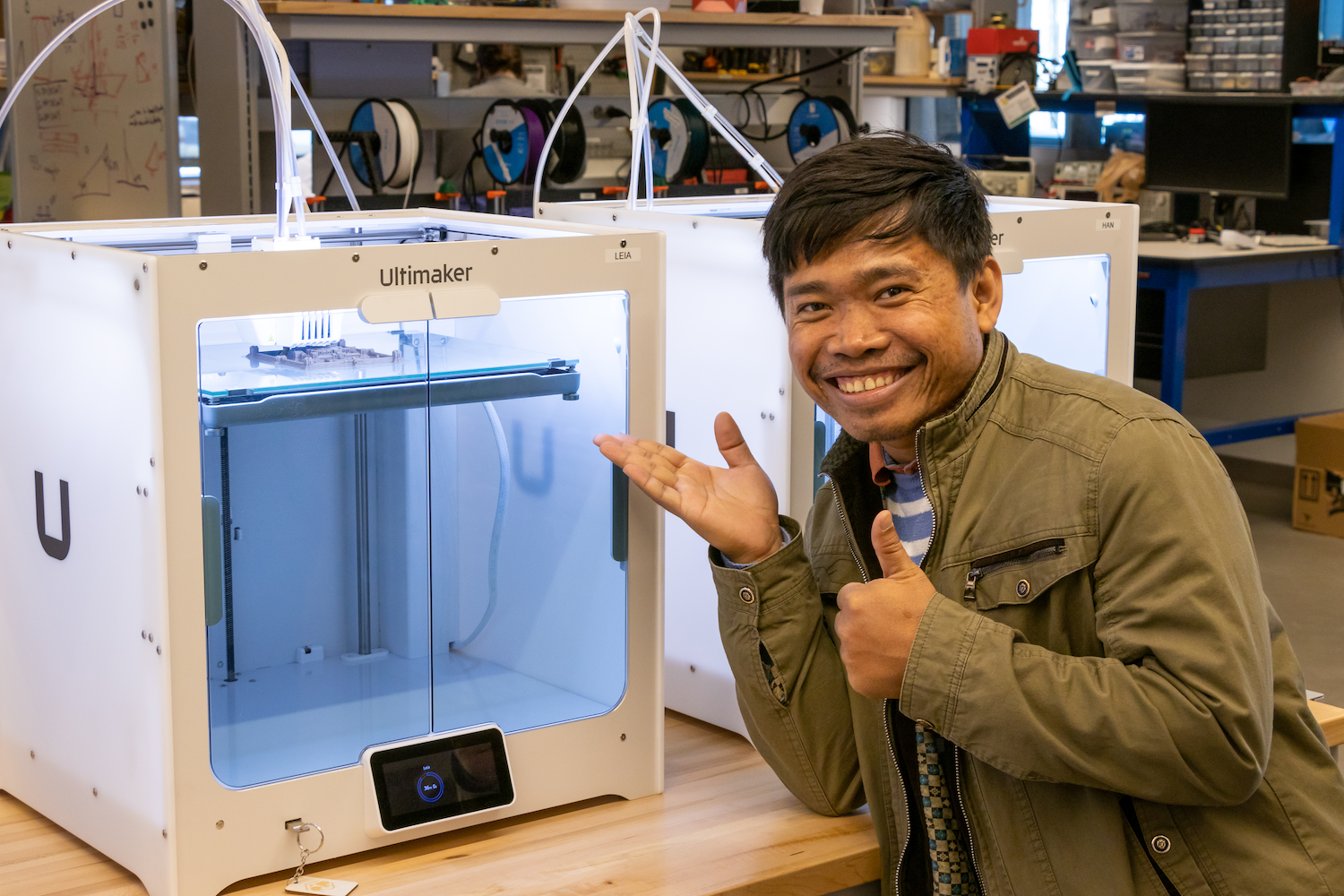 Kea smiling in front of 3d printing machine