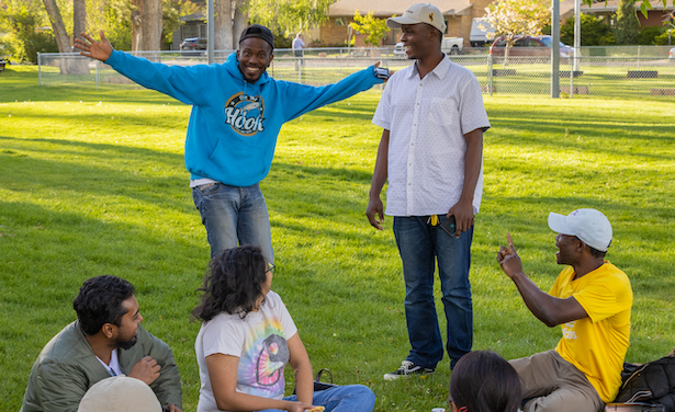 Five students smiling in a park in Laramie