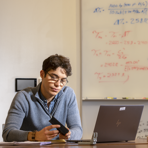 Student studying in front of a laptop