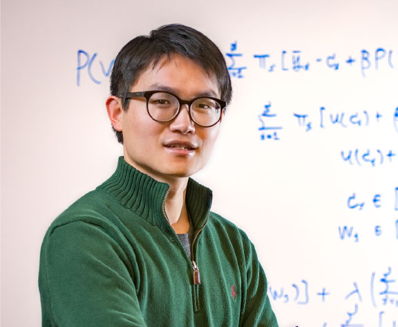 Man posing in front of whiteboard