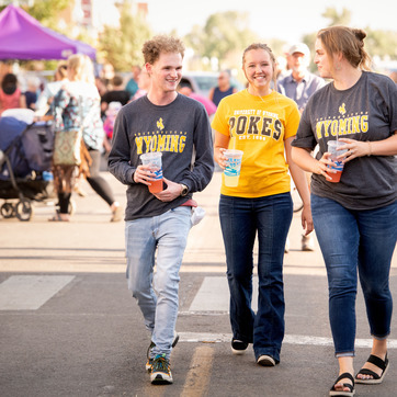 Three students walking downtown