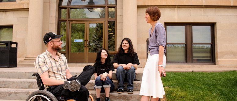 Professor and students sitting outside the College of Health Sciences