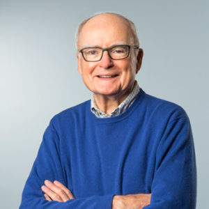 William D. Ruckelshaus weaing blue sweater.