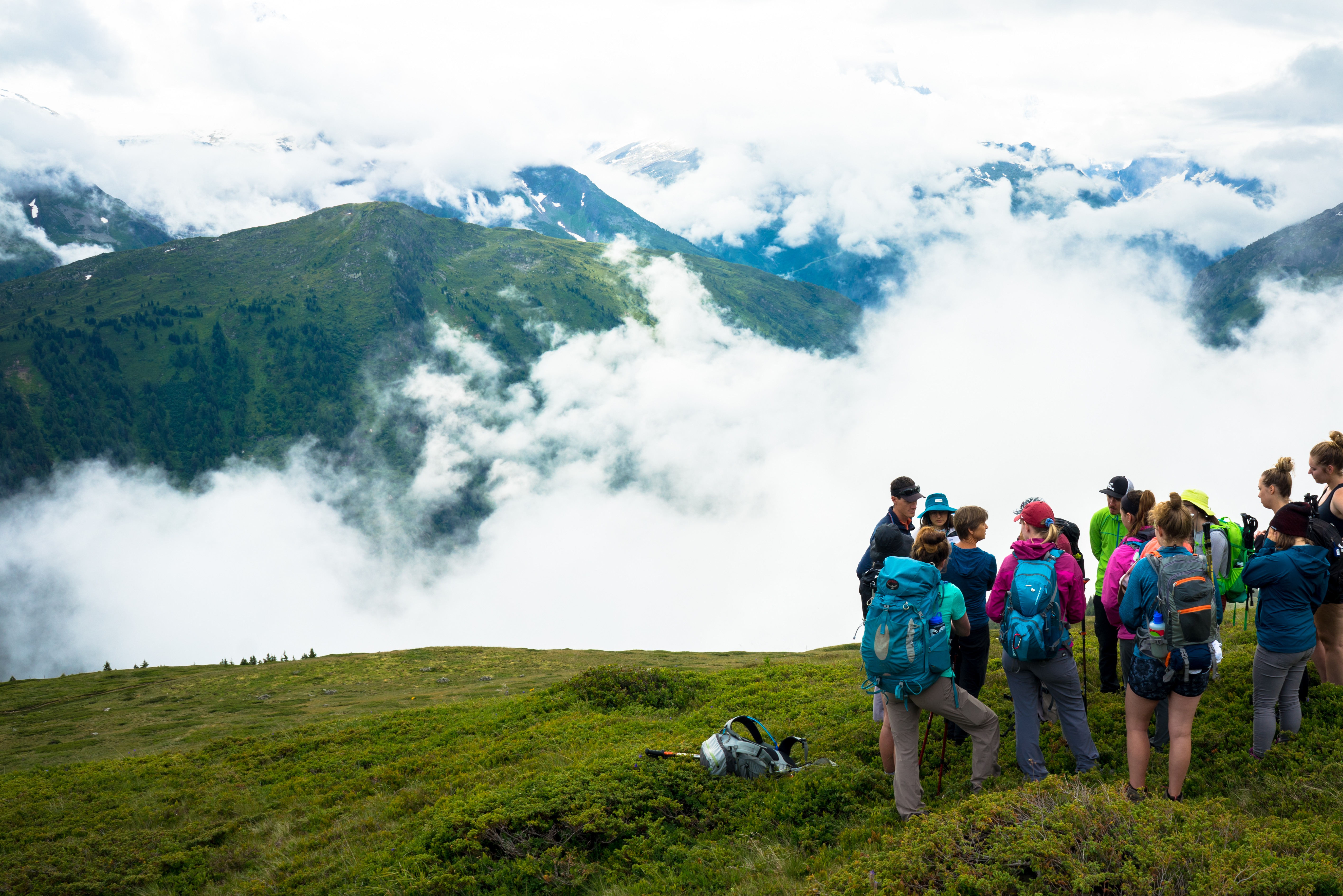 a group of students in a mountainous landscape with clouds