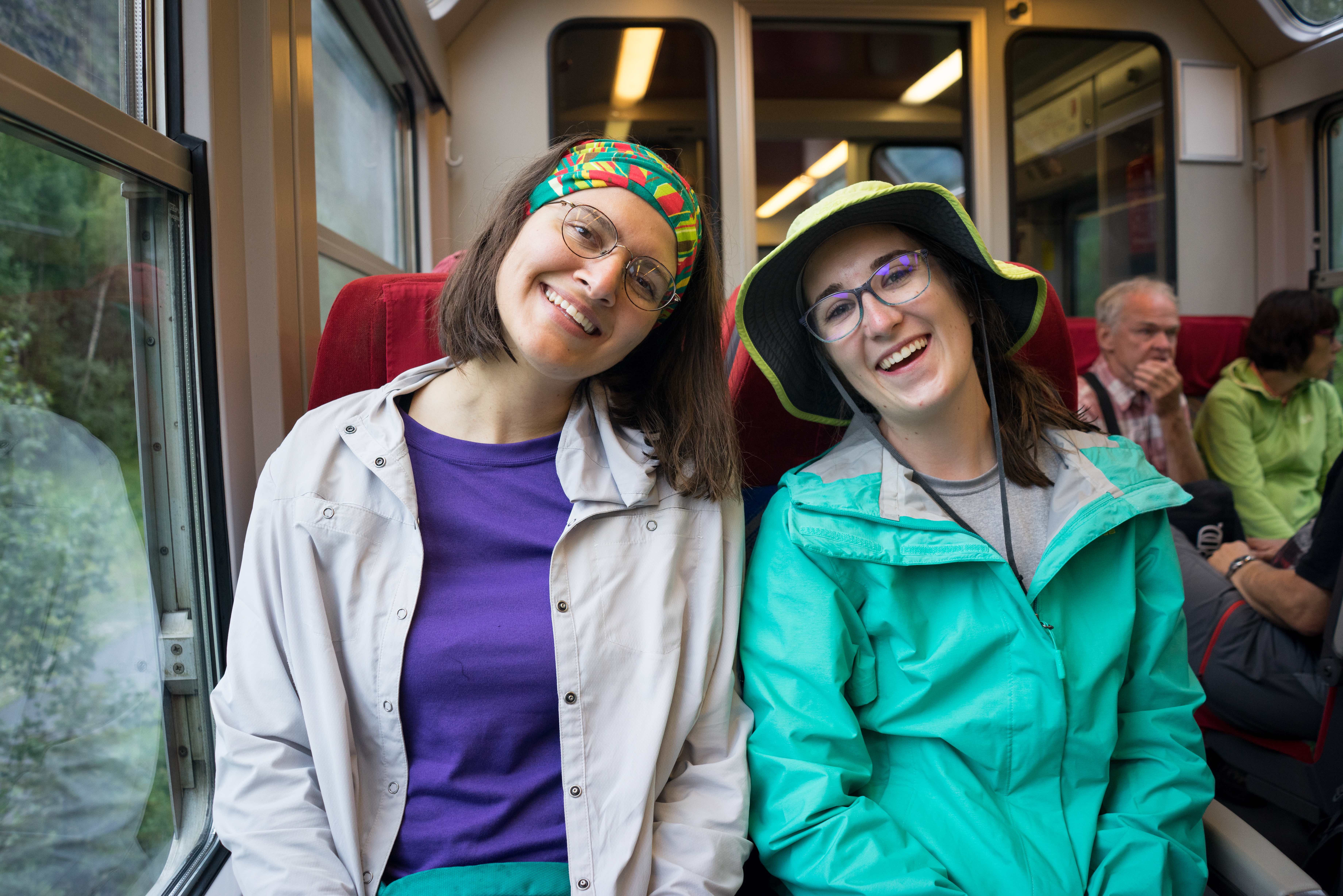 two students smiling on a train