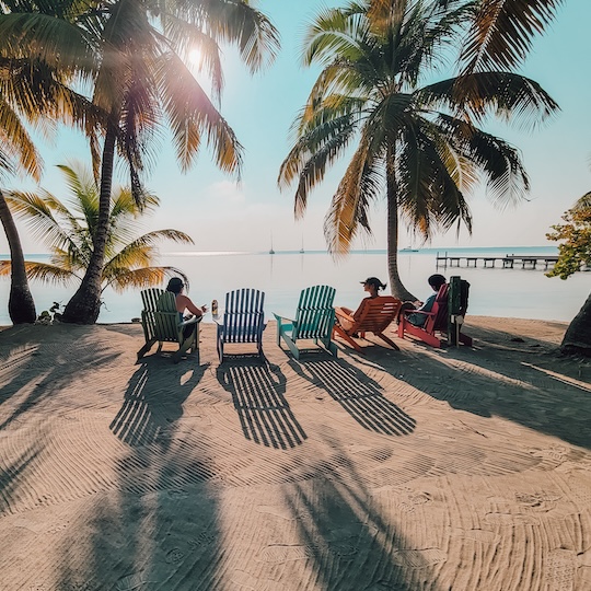 students in chairs by beach