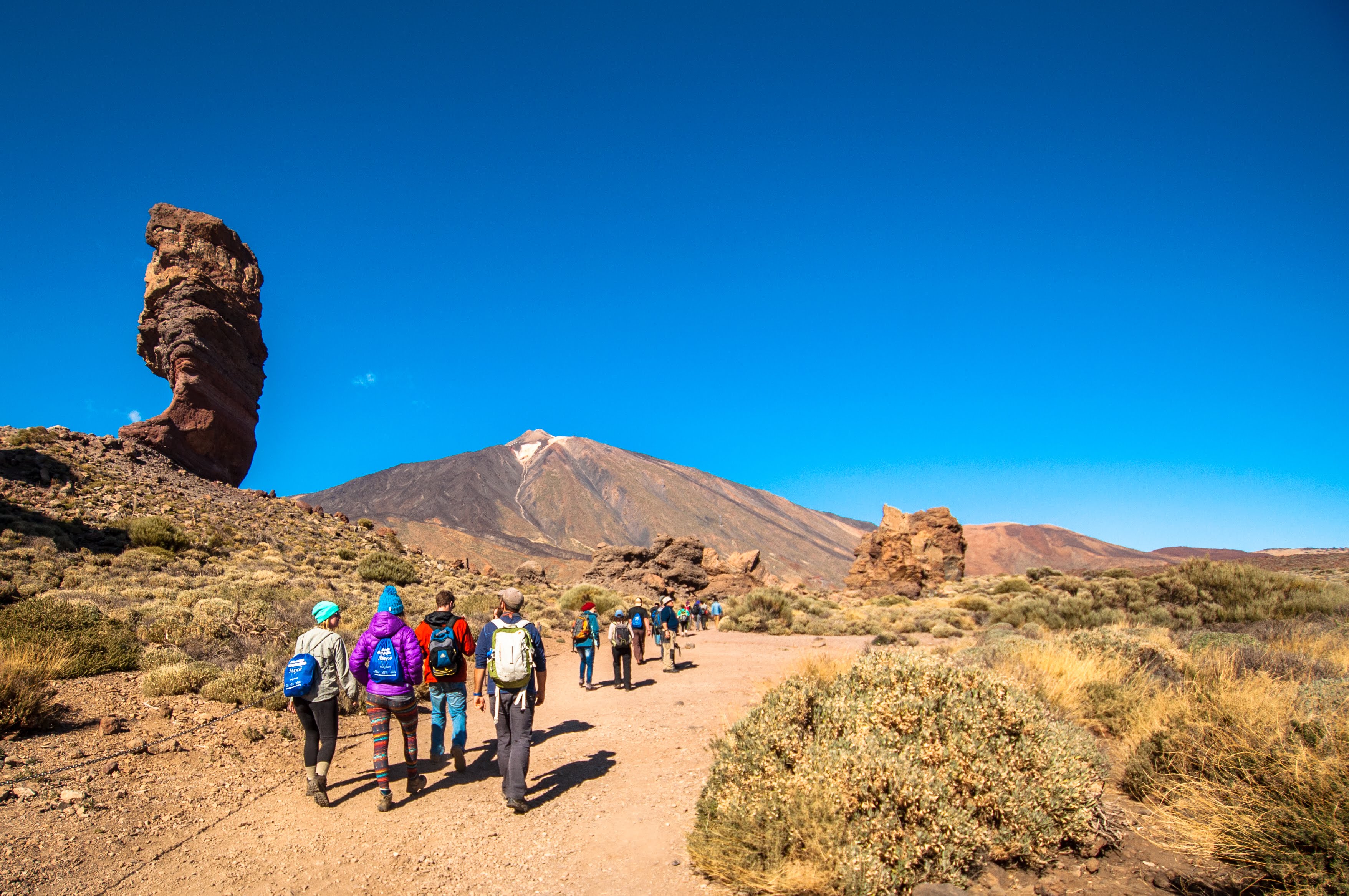 students hike in volcanic landscape
