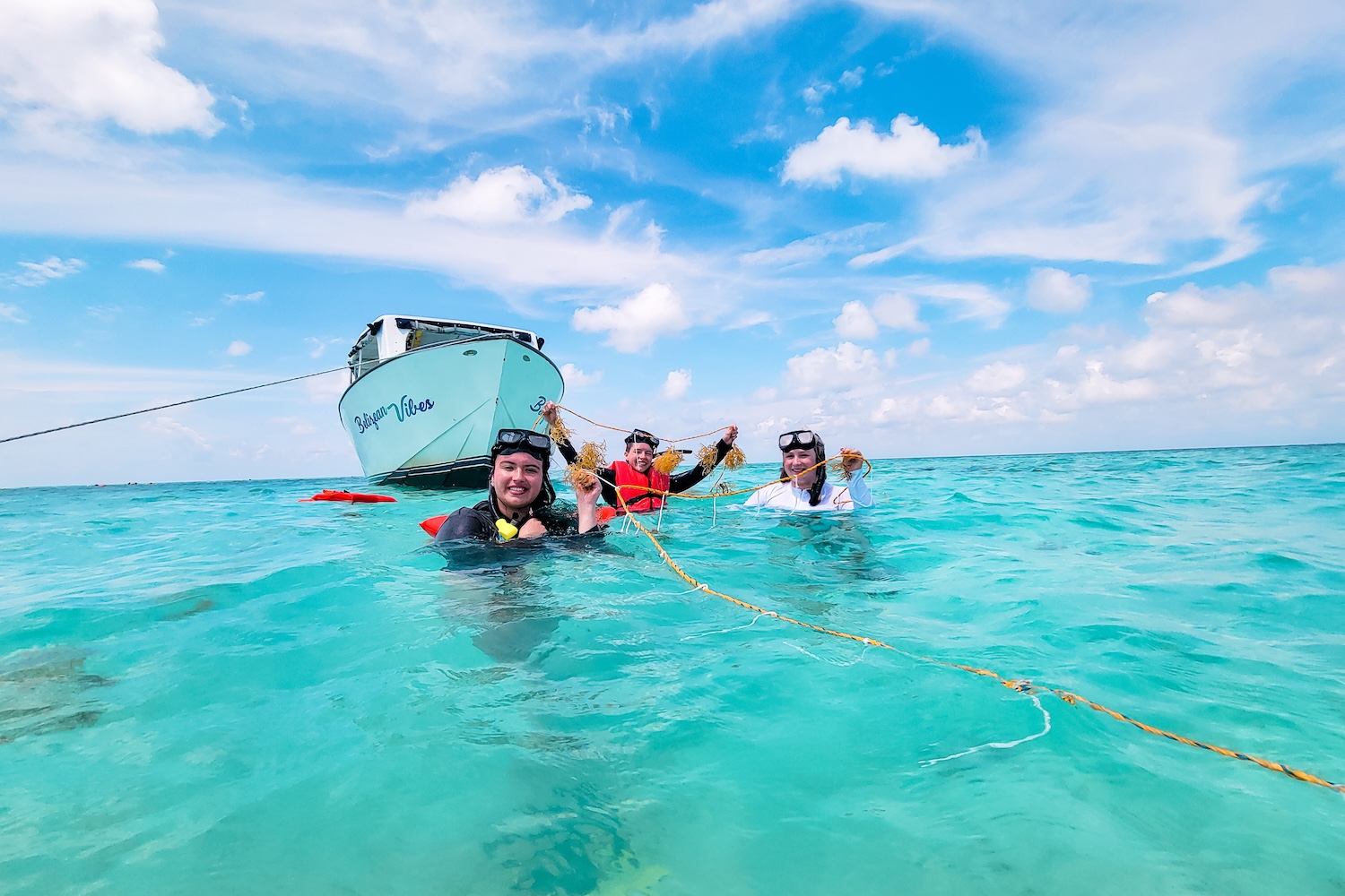 Students snorkeling by a boat