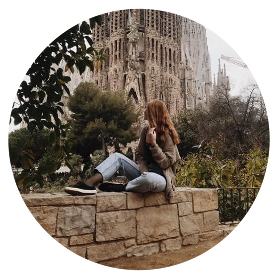 Maddie sitting on rock wall