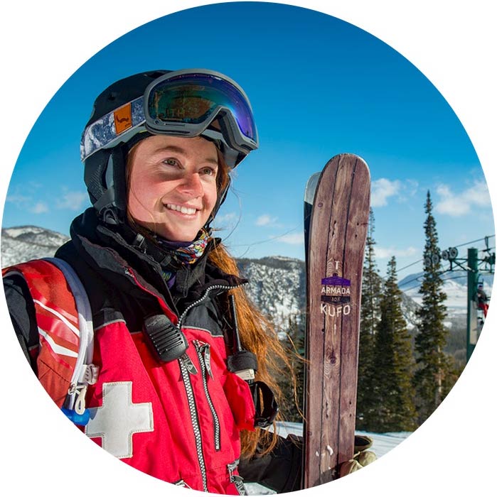 Ski patrol student holding skis