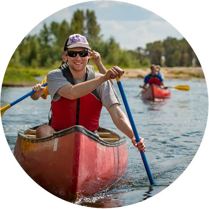 Student rowing in canoe