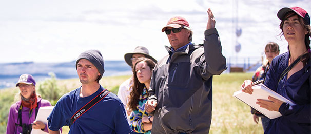 Students out in the field listening to instructor