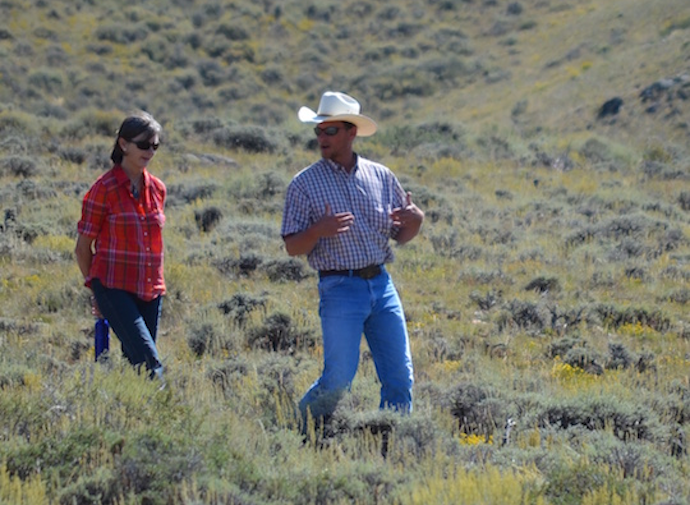 Picture of two people walking in sage brush