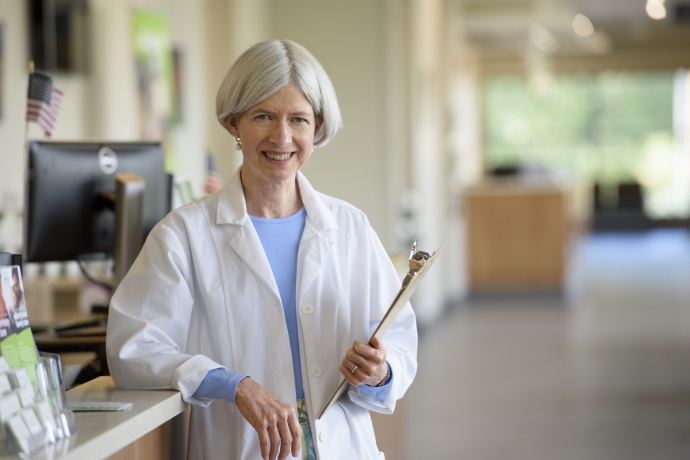 white female doctor with clipboard