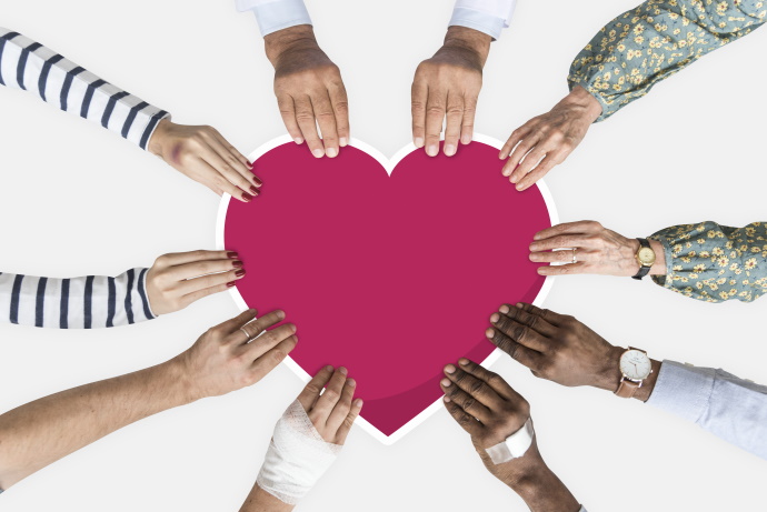 hands holding a heart shaped cutout