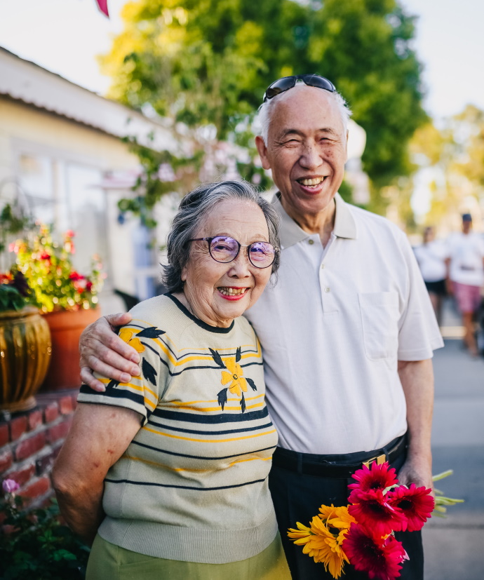 happy older couple with flowers
