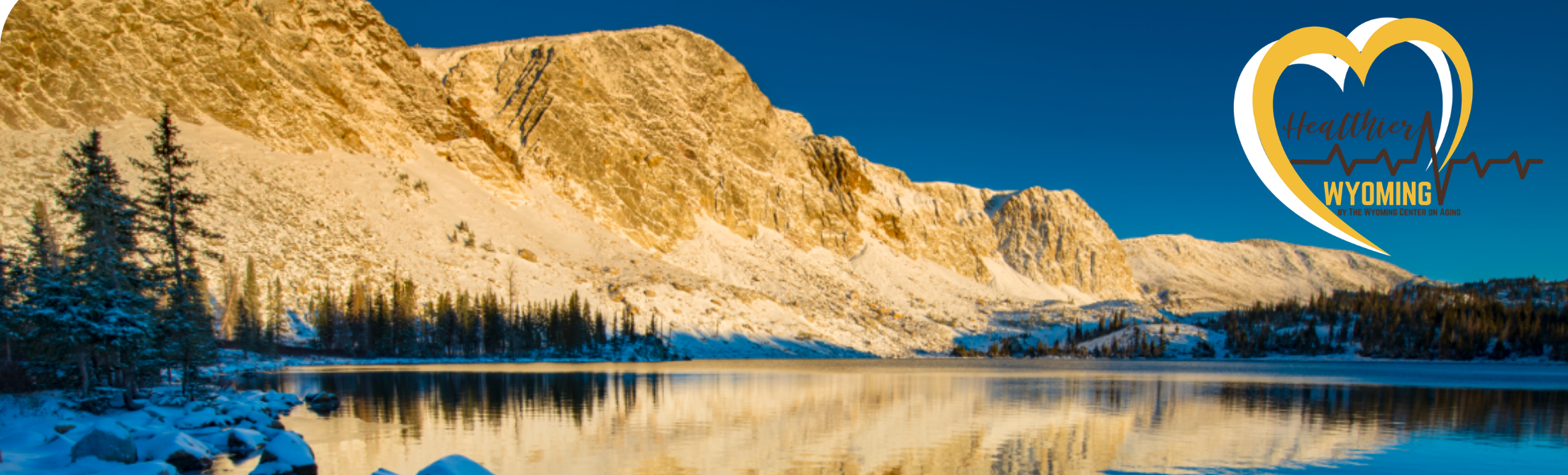 mountains and lake with Healthier Wyoming heart logo in right upper corner
