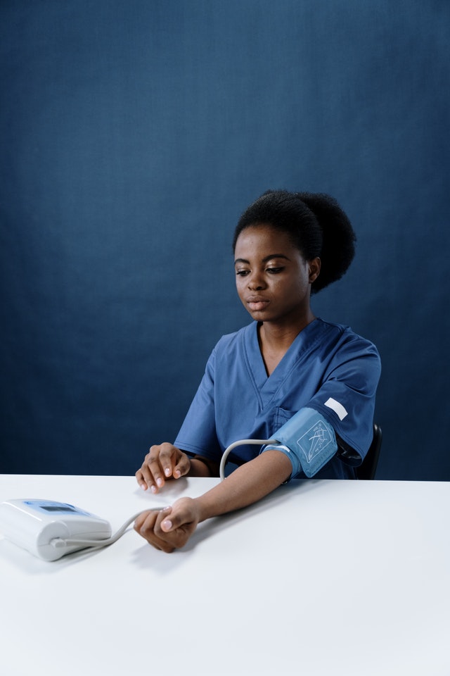 woman taking her own blood pressure