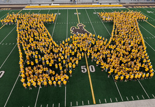 Photo of students creating a W on the football field