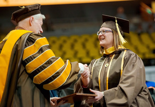 Photo of Master's Student being handed diploma