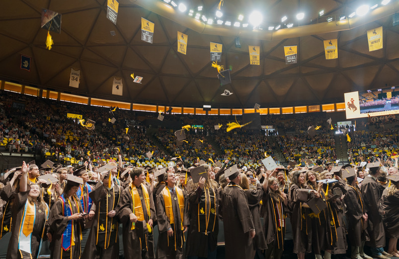 Photos of graduating students throwing graduation caps