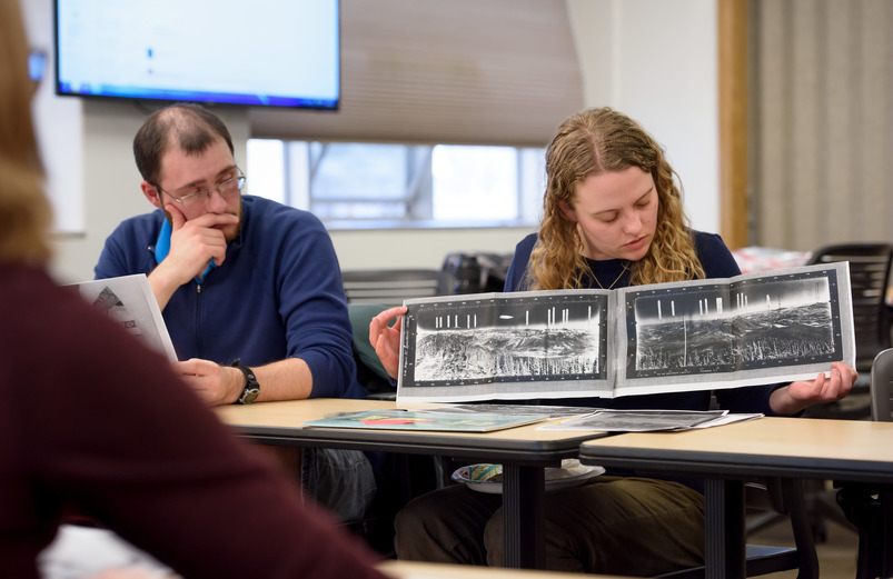 Student examining archives in class 