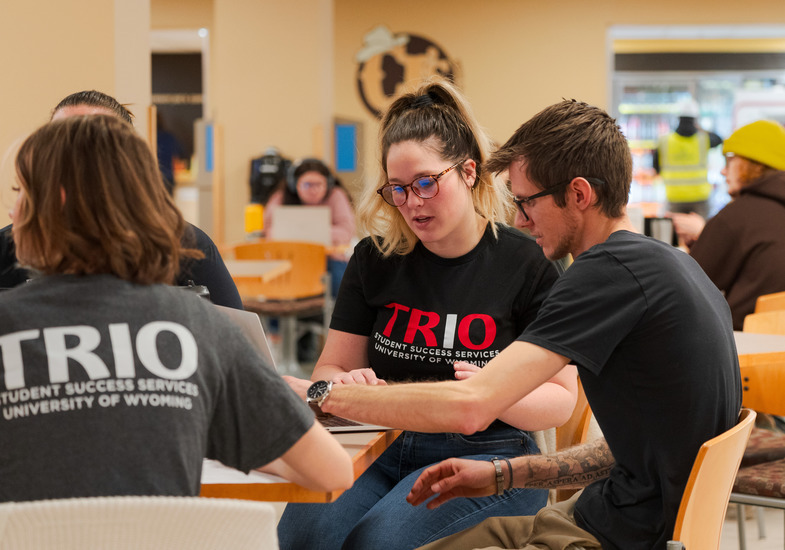 Photo of Student Success Service TRIO advisors helping students with their FAFSA applications