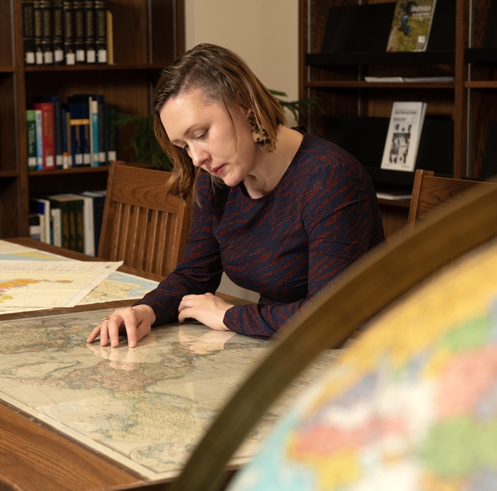 Faculty studying a map