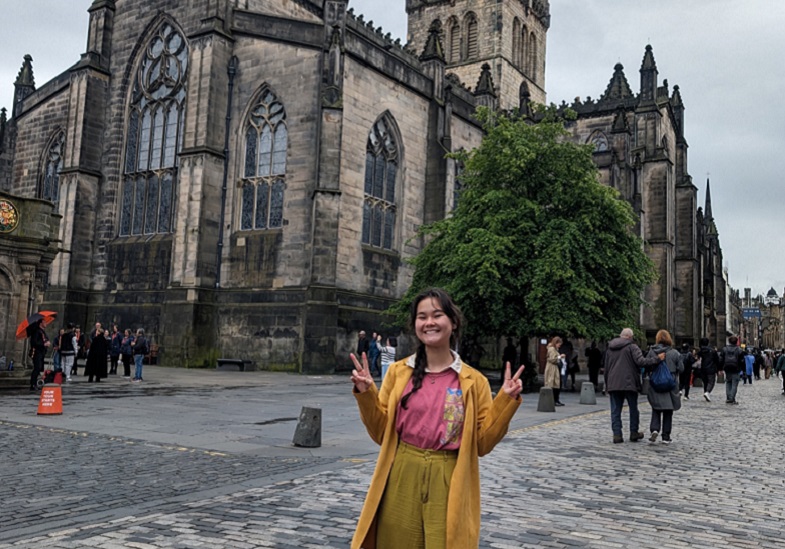 Jasmin Mahoney standing in front of a historical work of architecture.