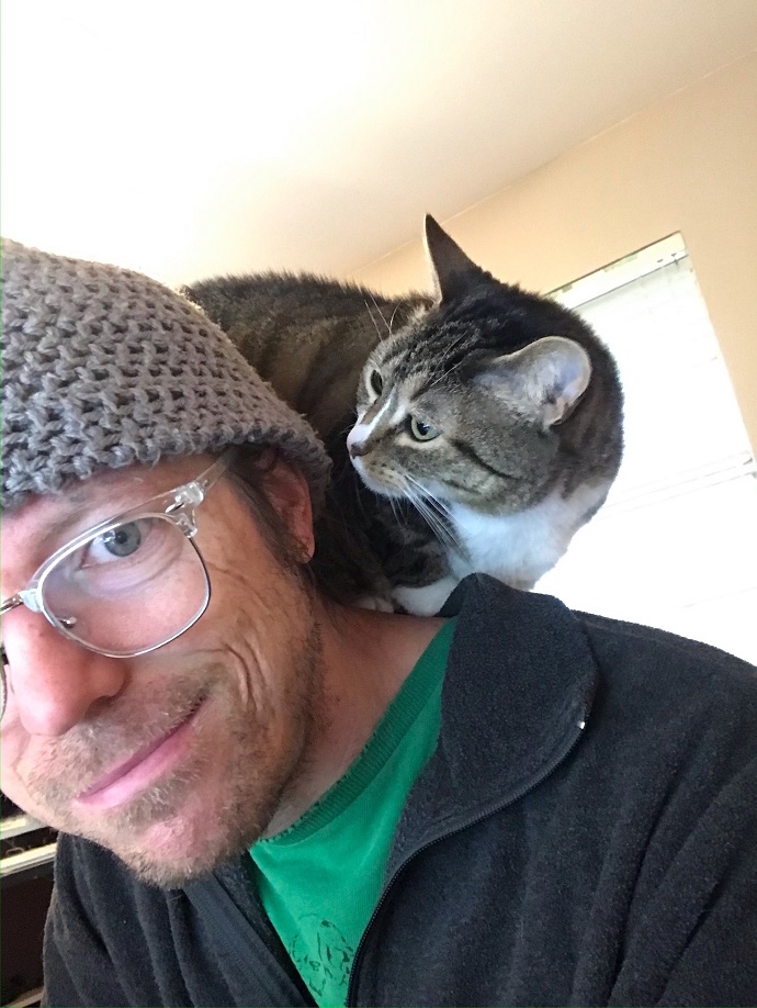 Daniel Gray with cat sitting on shoulders