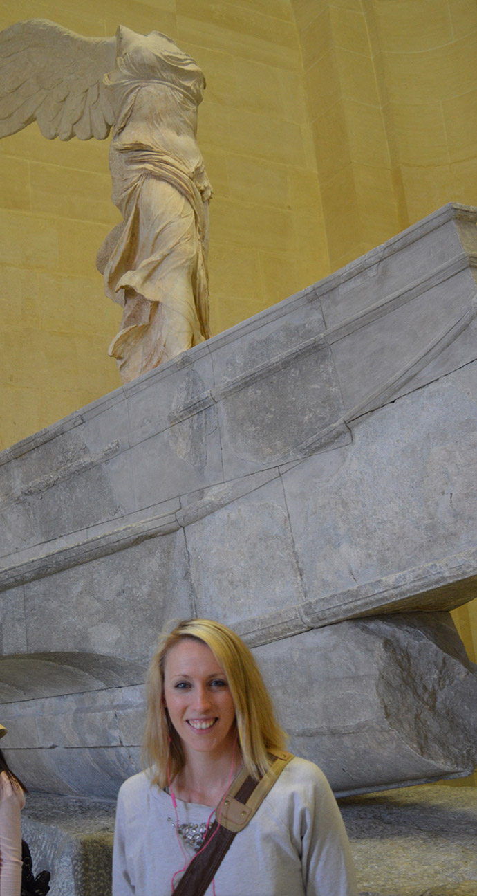 woman in front of a statue