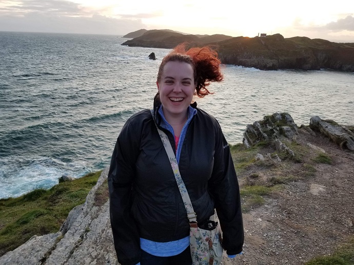 Mandie Reish standing in front of an ocean landscape