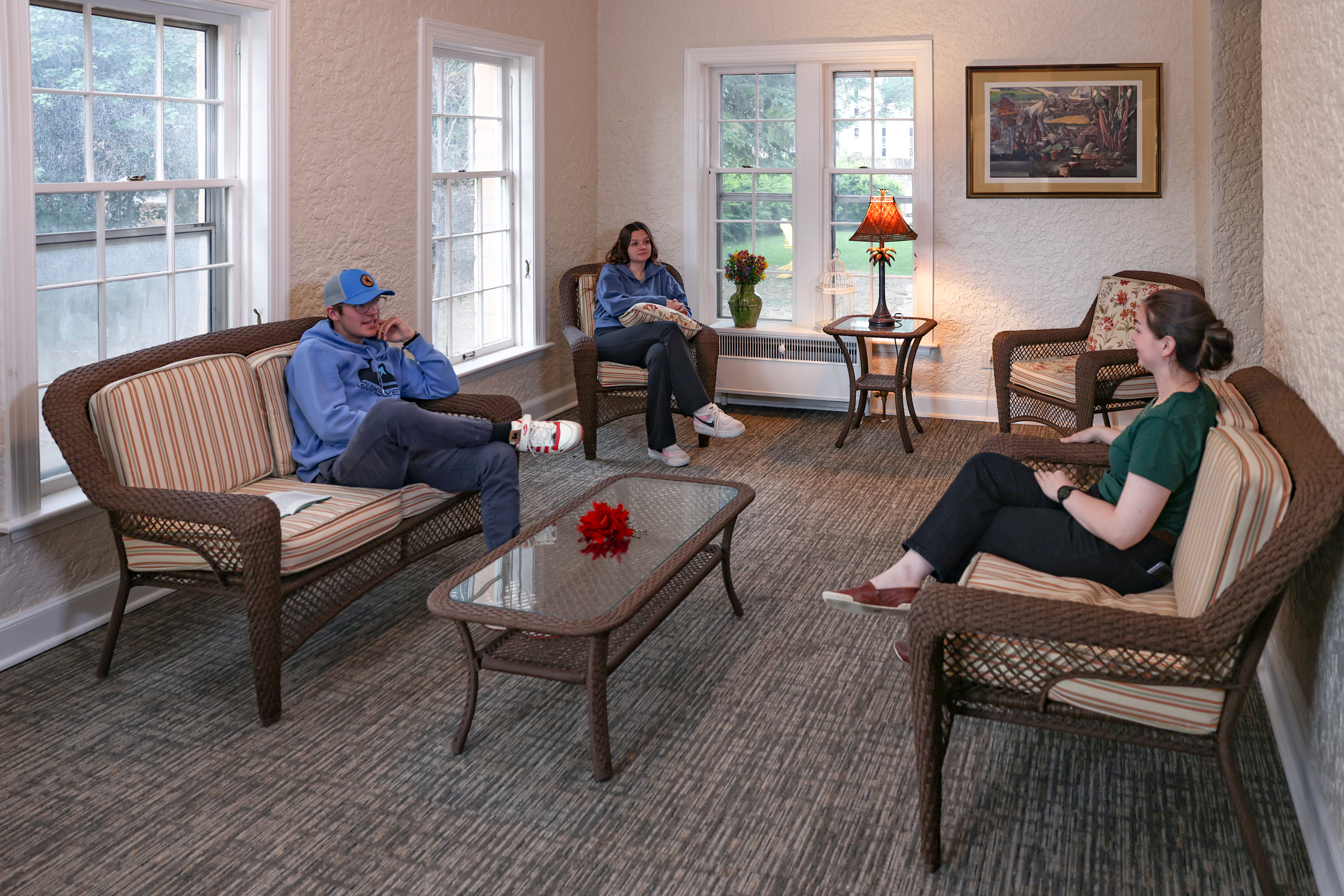 Group conversing in the sun room in Tobin House