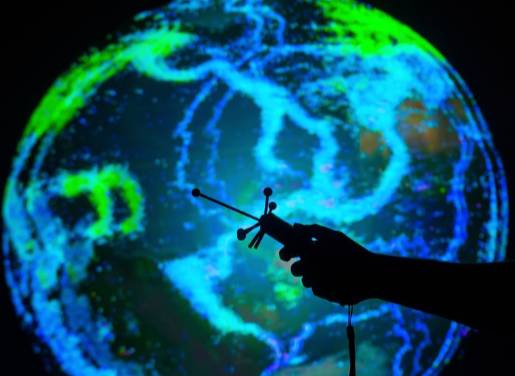 A hand utilizing a virtual, interactive globe