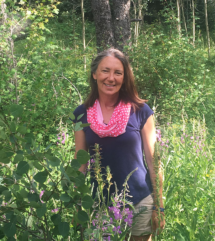 woman standing in wooded area