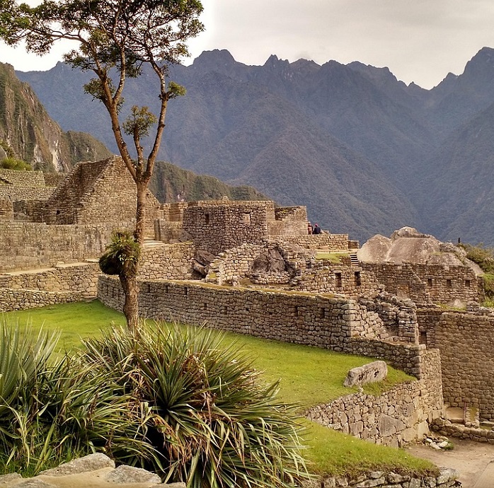 Macchu Picchu skyline with architectural ruins built into the mountain.