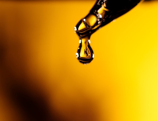 water dropping from a pipet in a yellow background. A steamboat logo appears in the water droplet.