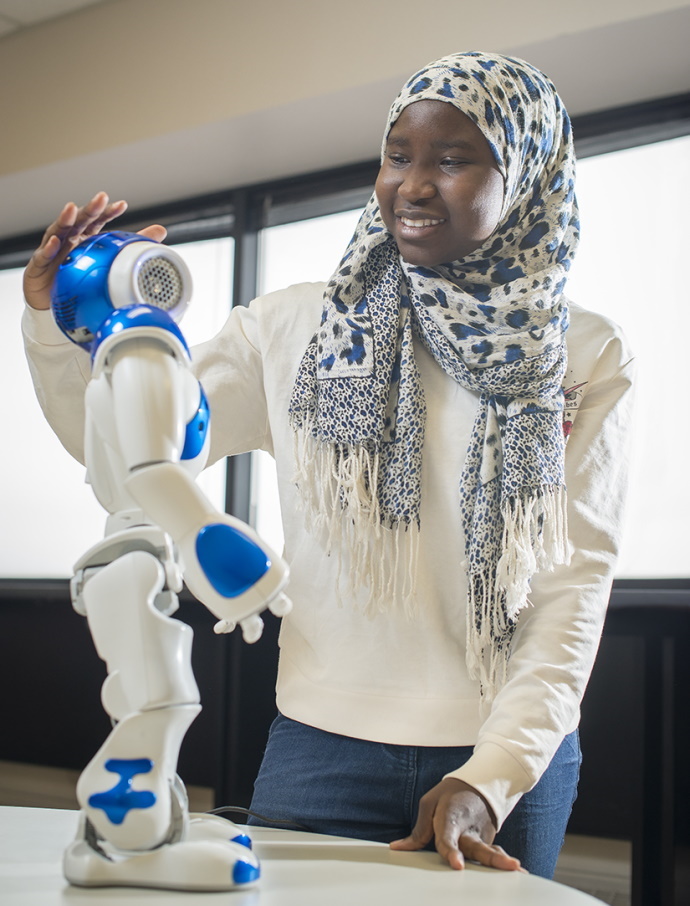 Student interacting with robot
